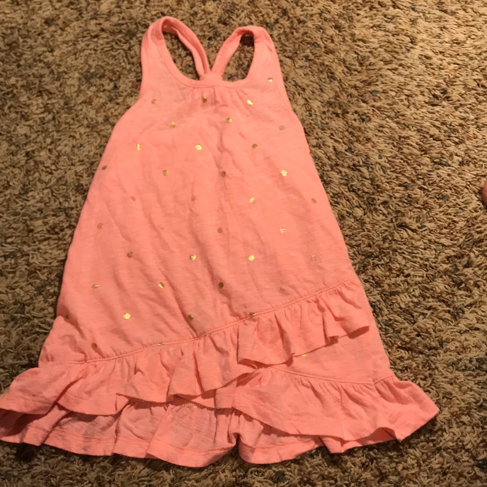 Orange tank top with gold dots and crossed bottom